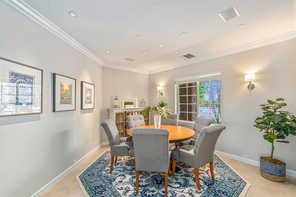 The dining room set for a family-style dinner with linens and fresh flowers